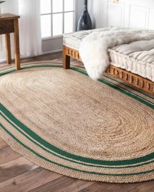 Oval jute rug with green border on hardwood floor