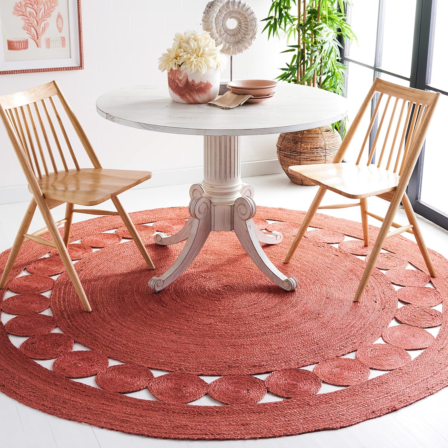 Red_Area_Rug.jpg Round jute rug under a white dining table with two wooden chairs.