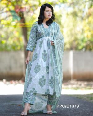 Woman in white and green floral print salwar kameez with dupatta.