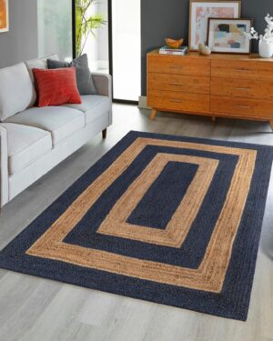 Navy blue and natural jute area rug with geometric border design in modern living room