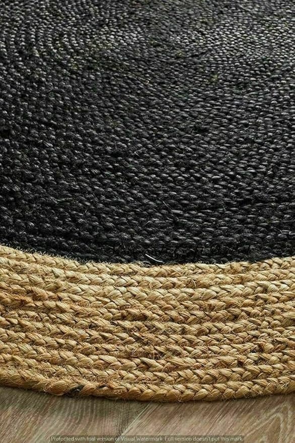 Black and Natural Jute Rug Detail Detailed view of a round jute rug showing a black center and a natural braided border.